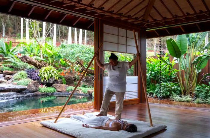 A spa therapist provides services to a guest at Sensei Lanai.