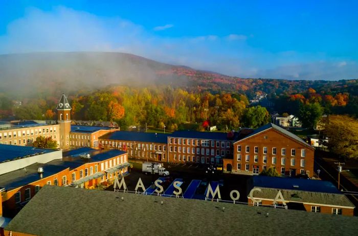 A scenic view of MASS MoCA against the backdrop of surrounding mountains