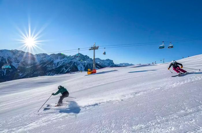 Skiers descend a snowy mountain