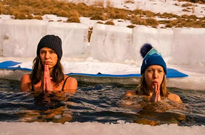 Two guests enjoy an ice plunge pool at Sand Valley resort in Wisconsin.