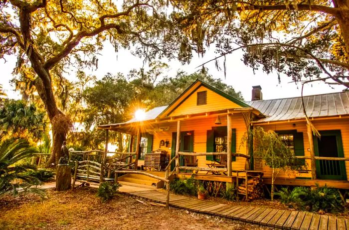 A yellow-toned lodge nestled among lush vegetation