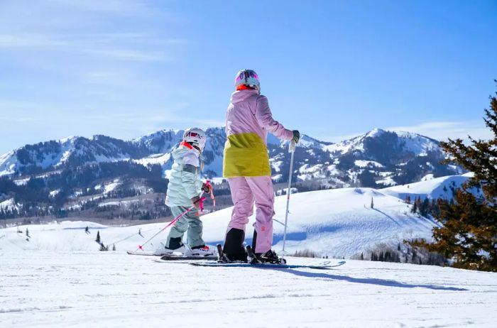 A skier and a child enjoying the slopes in Deer Valley, Utah