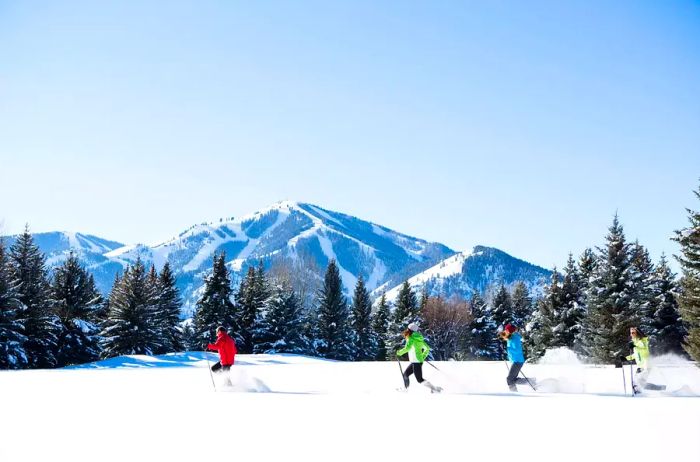 A family snowshoeing in Sun Valley under a clear winter sky.