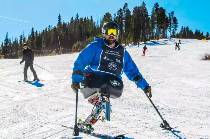 A paraplegic individual skiing down a slope