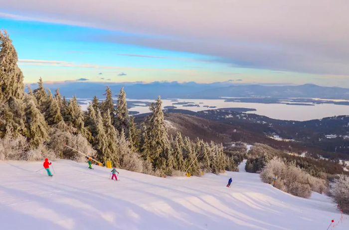 Skiers descending a run at Gunstock Mountain