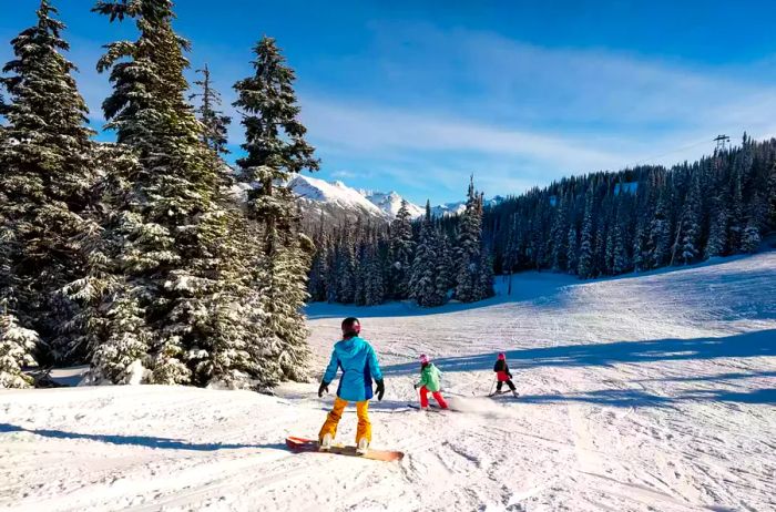 A mother and her daughters enjoying a ski trip during the coronavirus pandemic. Family ski vacations.