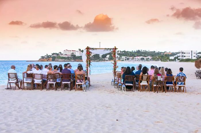 Guests seated at a wedding on the beach