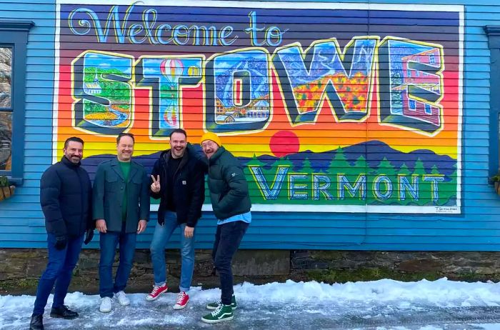 A group of men in front of a mural in Stowe, Vermont