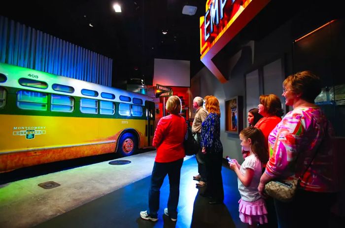 Visitors admiring a replica of a bus at the Rosa Parks Museum