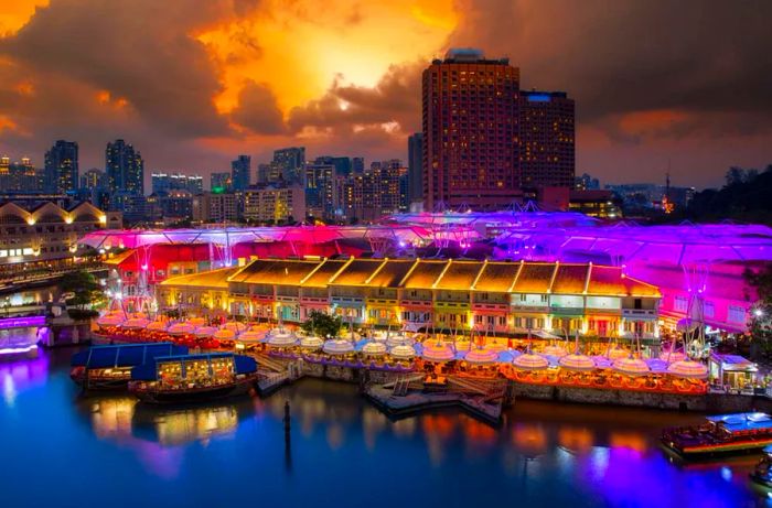 Vibrantly lit buildings in the food market area at night, Singapore city, Singapore