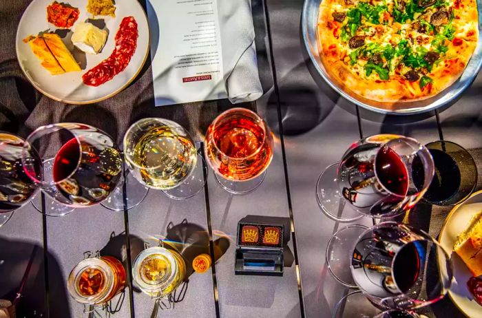 Indulge in four exquisite wines complemented by a picnic spread featuring cheese and salami crafted from Martinis Napa Valley Cabernet, duck rillette, truffle popcorn, and a wild mushroom and truffle pizza at Martini Park, Louis M. Martini Winery, St. Helena, CA.