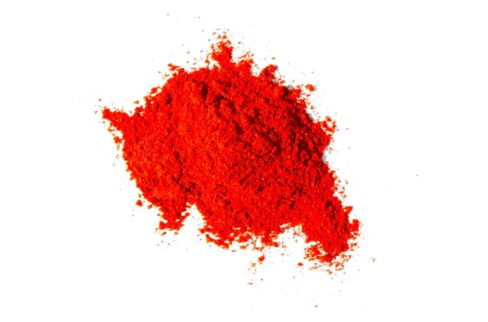 A mound of paprika from Burlap & Barrel, captured against a white background