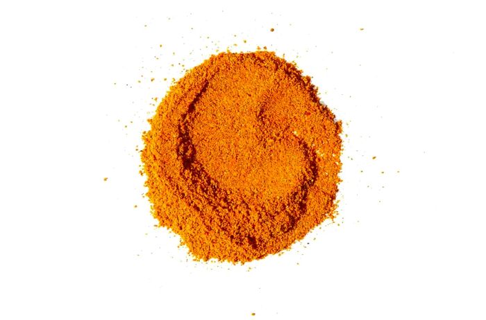 A mound of Mekko Spice Rub from Essie Spice, captured against a white background