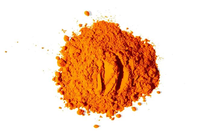 A heap of turmeric from Diaspora Co, captured against a white background