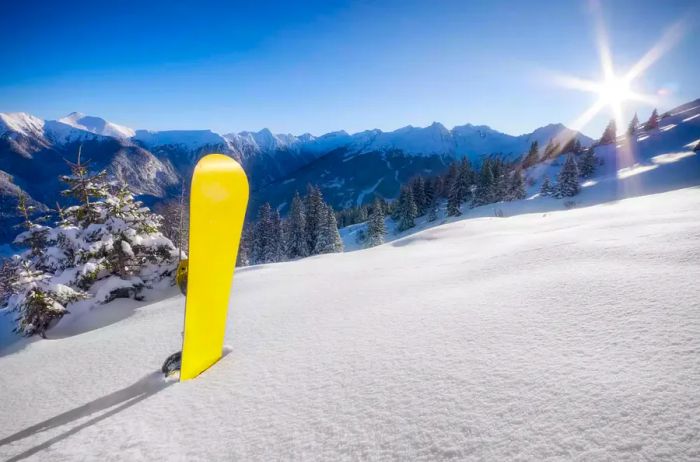 Powder snow and a snowboarder enjoying a sunny day in the Alps