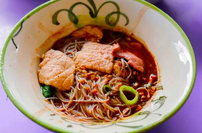 Boat noodle soup, widely cherished in Thailand for its rich flavors and unique presentation.