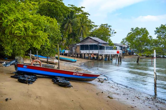 A view of the beach and wooden jetty on Pulau Ubin, Singapore.