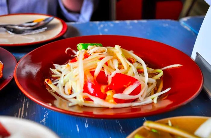 Som Tum is a traditional Thai papaya salad, bursting with fresh flavors.