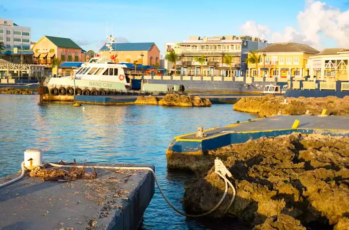 The setting sun bathes the charming George Town waterfront in a warm glow, Grand Cayman, Cayman Islands