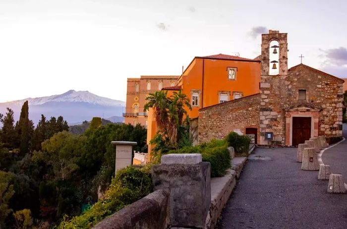 A scenic view of buildings and mountains in Sicily