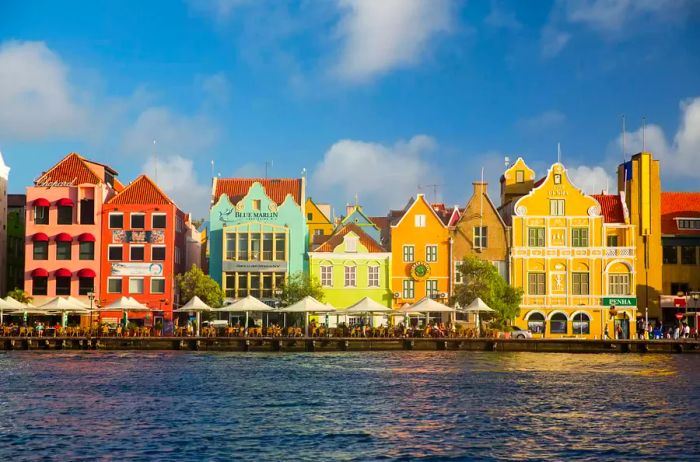 A row of traditional, multicolored houses lining the waterfront in Punda, Willemstad, Curaçao, Caribbean.