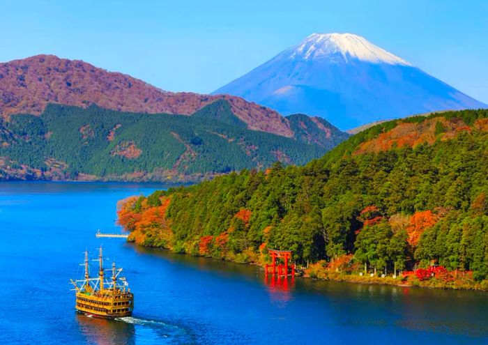 Mount Fuji and Lake Ashi, featuring the Hakone temple and sightseeing boats, amidst the beauty of autumn.