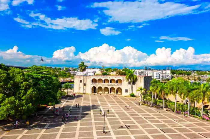 Alcazar de Colon, the residence of Diego Columbus on Spanish Square. Tourists stroll through the Colonial Zone of Santo Domingo, Dominican Republic. High-quality photo