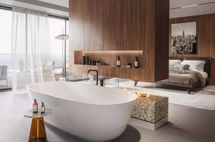 Elegant interior of a luxury hotel room featuring a bathtub near a fireplace, with a bed in the background