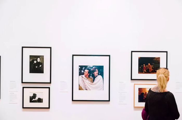 A woman admires photographs in the National Portrait Gallery.