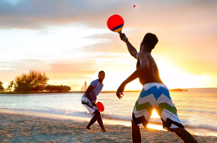 Individuals engaged in a game on the beach