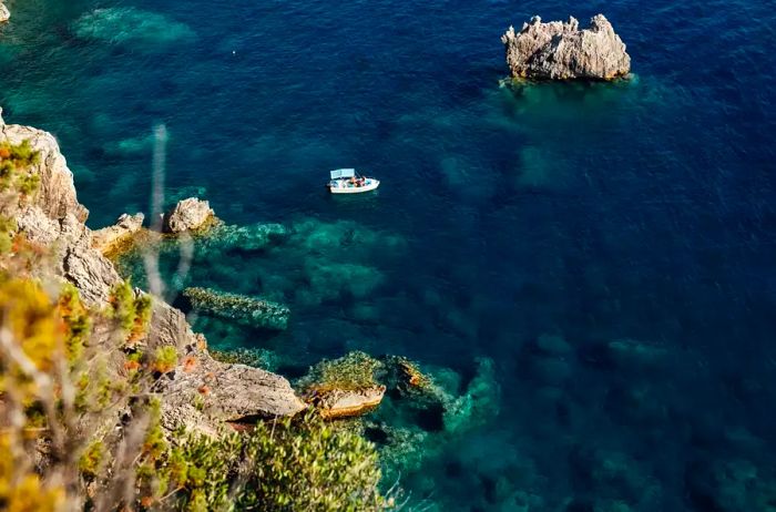 Aerial view of a boat floating in the waters near Corfu