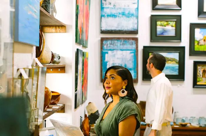 A couple admiring artwork at Bajo El Sol.