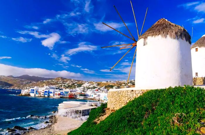 Iconic white windmills overlooking Little Venice and Mykonos old town, Mykonos, Cyclades, Greece