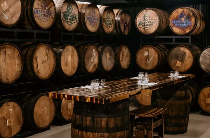 A tasting table surrounded by barrels at Nashville Barrel Company