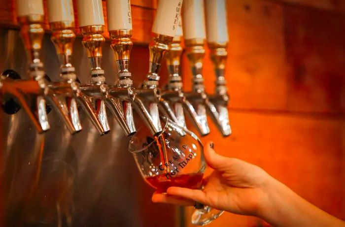 Pouring beer from the tap at Black Abbey Brewing Company