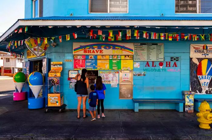 A family enjoying their order at Waiola Shaved Ice