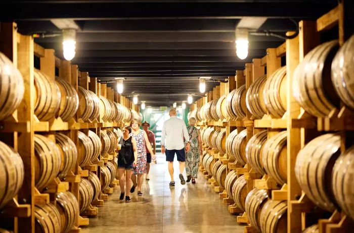 Visitors exploring barrels at Nearest Green Distillery