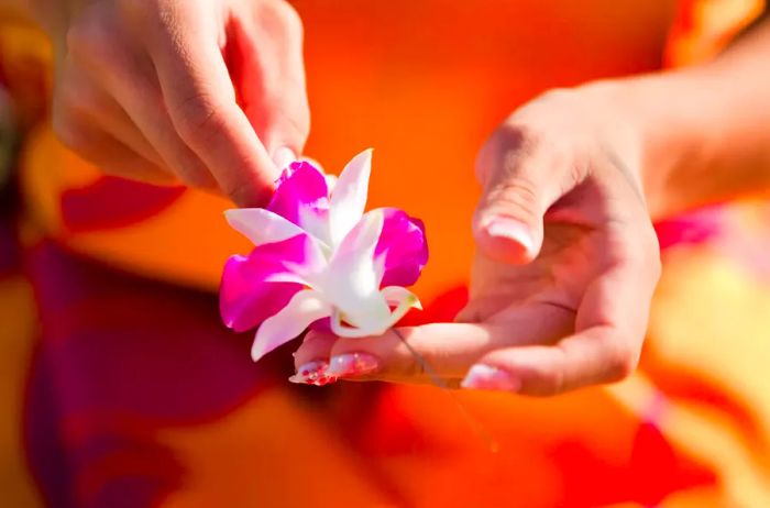 A woman creating a lei