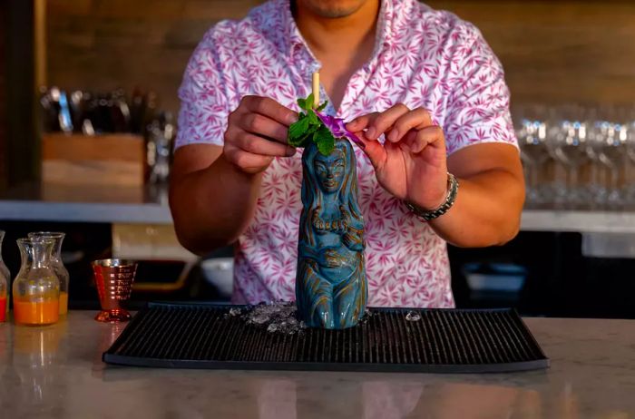 A bartender crafting a tiki drink at Fete