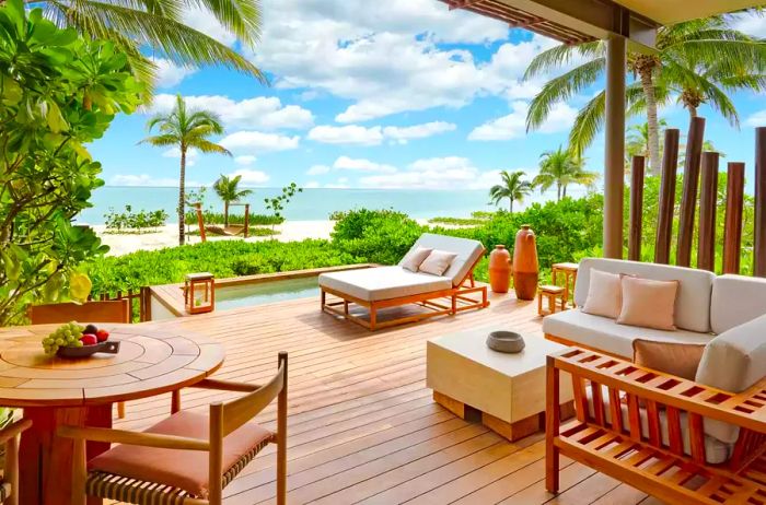 Patio of a guest suite overlooking the beach at Rosewood Mayakoba