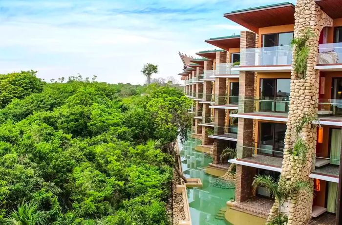 View of the exterior of rooms overlooking a lush tree canopy