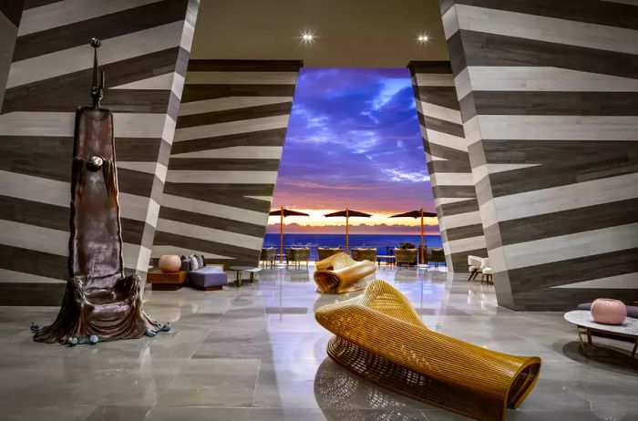 Main lobby featuring art sculptures and a view of the sunset over the beach