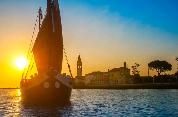 Eolo boat at sunset near Burano, Italy