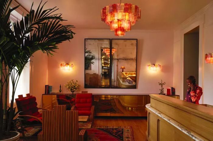 Interior view showcasing a contemporary art deco lobby with a guest at the reception desk