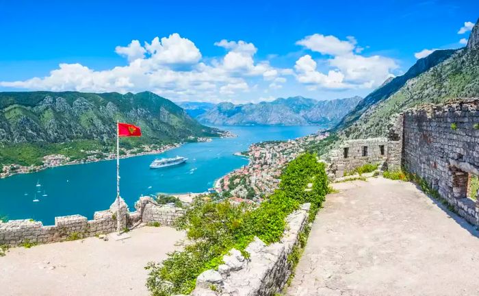 A stunning view of a Silversea cruise ship from the fortified walls of Kotor, Montenegro, overlooking the bay.