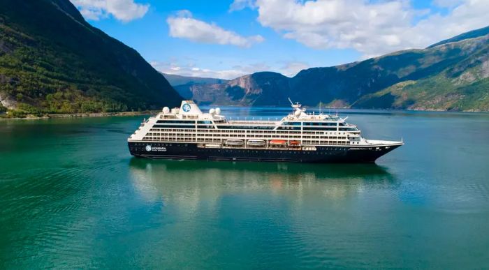 An Azamara ship navigating through a narrow channel.