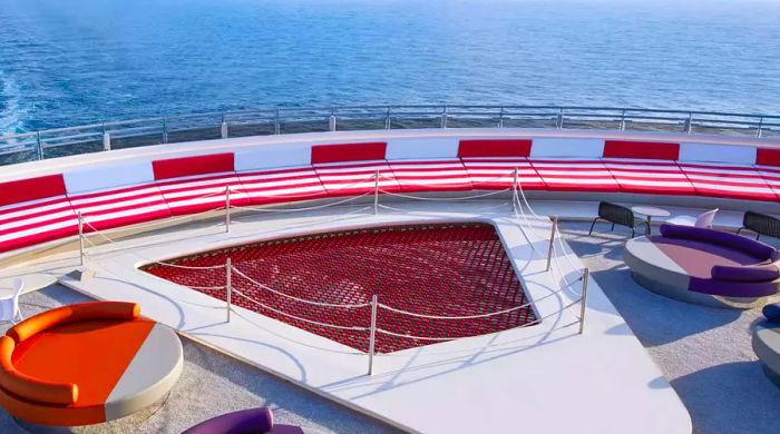 A deck view of a Virgin Voyages ship showcasing oversized loveseats and net seating.