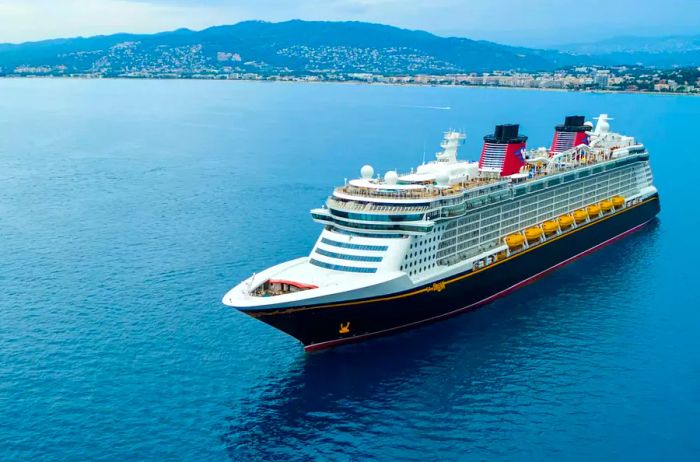 The exterior of a Disney cruise ship anchored off the Greek coast