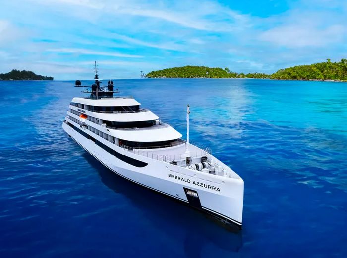 An aerial view of the Emerald Azzurra gliding through vibrant blue waters.