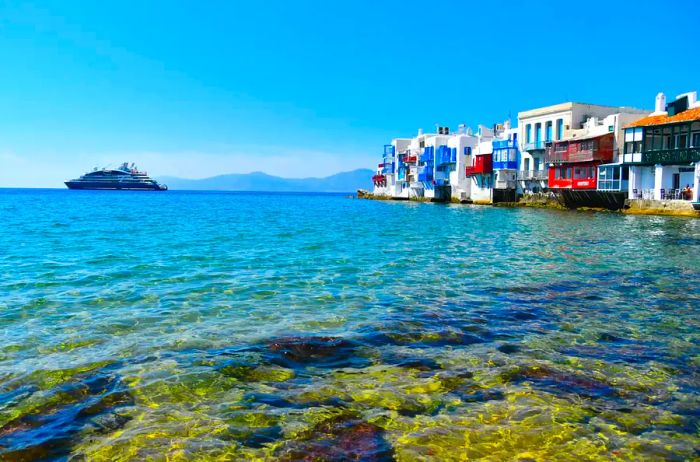 A boat sailing towards a Greek city